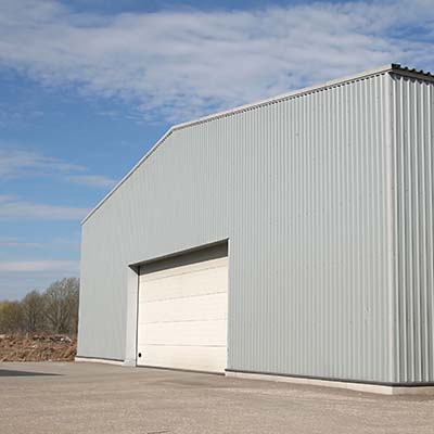 Gray warehouse commercial building without gutters.