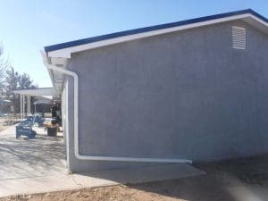 Seamless rain gutter on a pitched roof home.