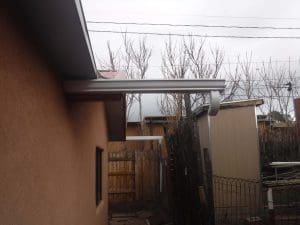 Seamless rain gutter on a pitched roof home.