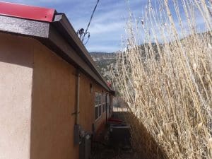 Seamless rain gutter on a pitched roof home.